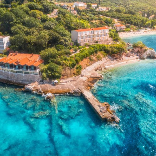 Aerial view with sea coast, sandy beach, blue water, hotels